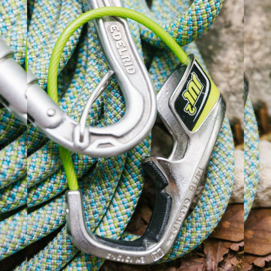 Edelrid Jul 2 Assisted Braking device in steel gray and lime green laid on top of green and blue rope
