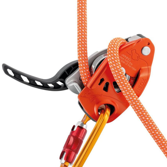 Petzl Neox Belay Device in Orange with rope threaded through device and carabiner attached. Neox Lever is in open position