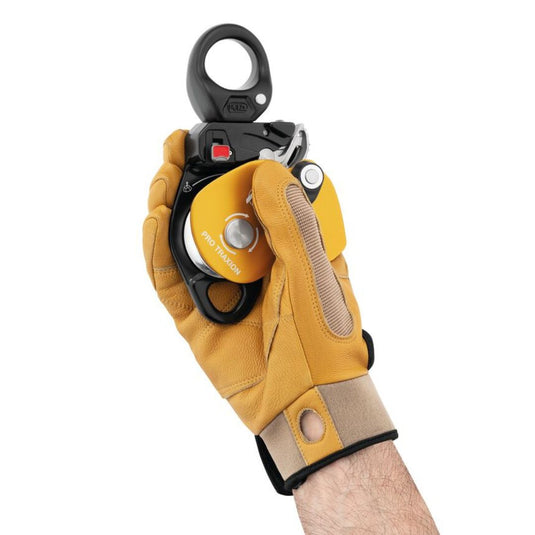 Petzl Pro Traxion: a yellow and black mechanical pulley in gloved hand