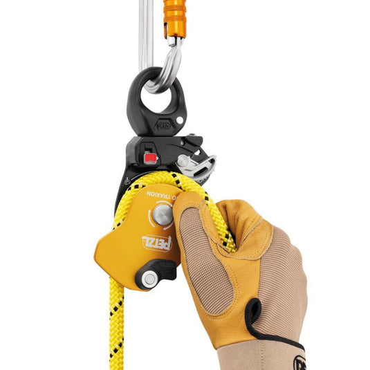 Petzl Pro Traxion: a yellow and black mechanical pulley with yellow rope in situ