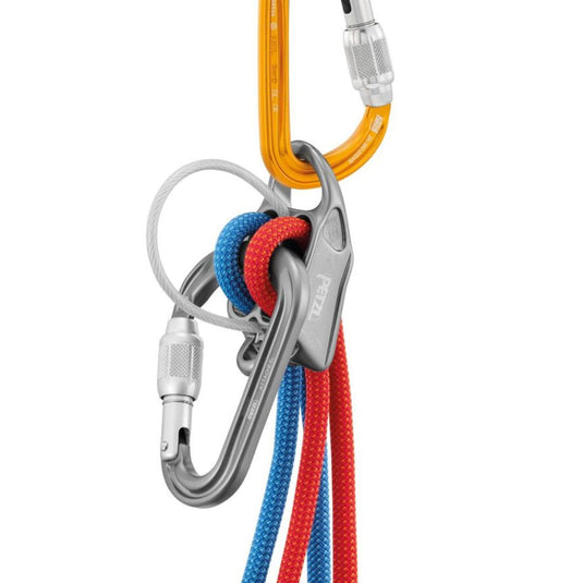 Petzl Attache Screw-Lock Carabiner attached to reverso belay device with red and blue rope threaded through