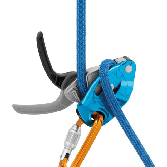 Petzl Gri Gri in Blue with blue rope threaded through and orange carabiner attached. Lever is in open position.