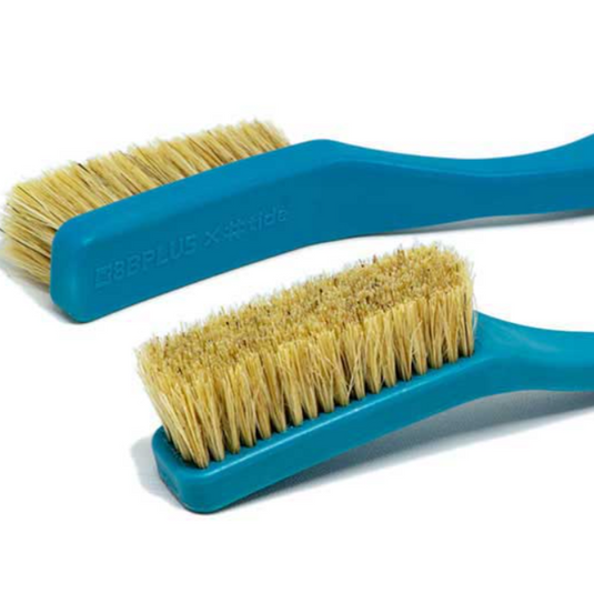 Two blue 8b+ plastic chalk brushes on white surface showcasing bristles