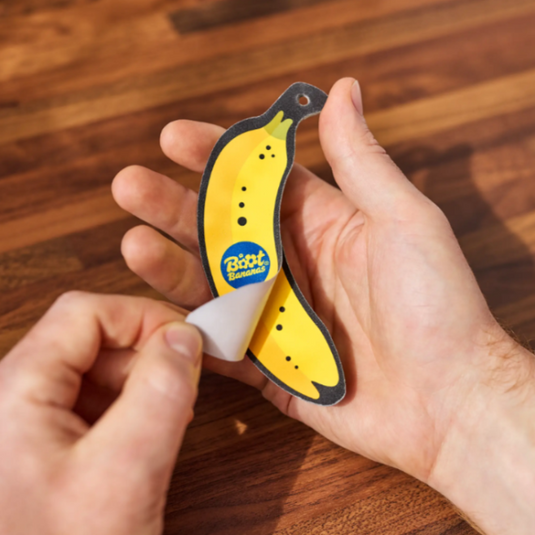 Boot Bananas Nail & Skin File in someones hands with top layer being peeled off