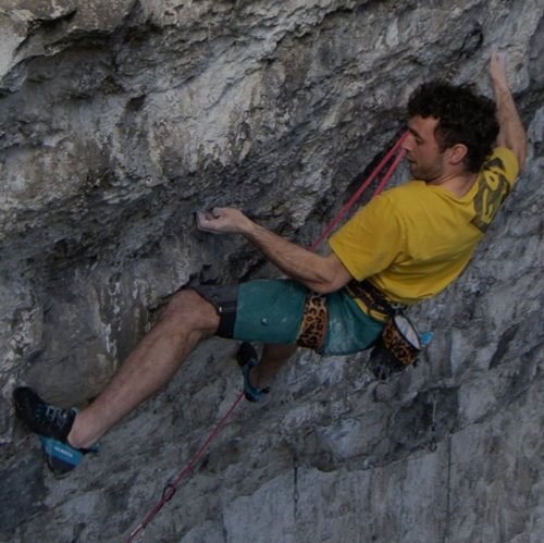 Blakpad VS kneepad worn on athlete climbing overhanging rock with leopard print harness