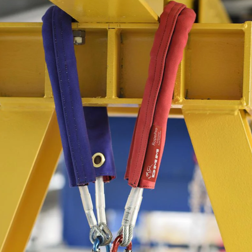 Blue and red DMM K-Pro rope protector in use on rope around yellow steel beam
