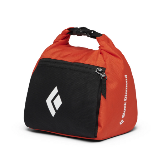 Black Diamond Team Chalk Pot Rolled up in orange and black design with black diamond logo on the front pocket