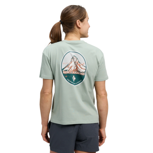 Black Diamond Women's Heritage Badge Short Sleeve Tee in agave - with large mountain design on back worn on model facing away