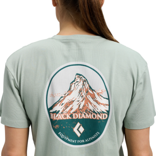 Black Diamond Women's Heritage Badge Short Sleeve Tee in agave - with large mountain design on back worn on model facing away