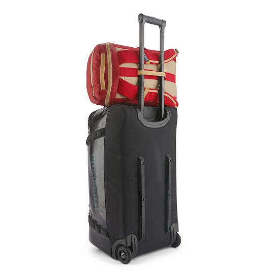 Patagonia Black Hole Pack 25L on top of suitcase