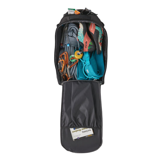 Patagonia Cragsmith in black -open and filled with various climbing equipment