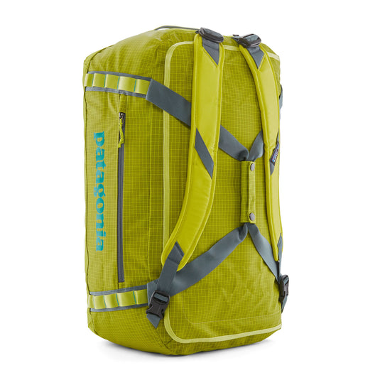 Patagonia Black Hole Duffel in phosphorus green showing shoulder straps in use