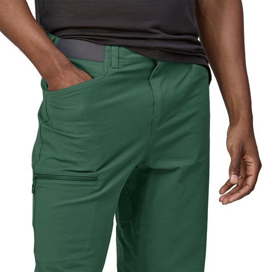 Patagonia Mens Venga Rock Pants in Green worn by model with hand in front pocket
