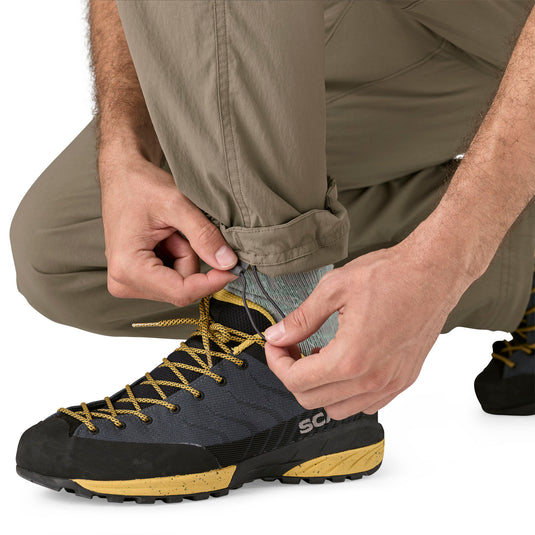 Patagonia Mens RPS Rock Pants in wing grey worn by model close up of leg cuffs