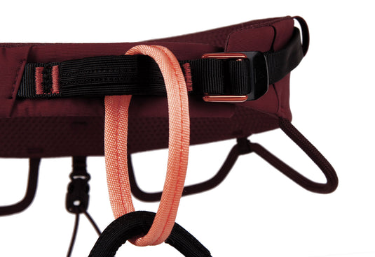 A close up of the waist belt of a red/brown coloured Blue ice cuesta harness