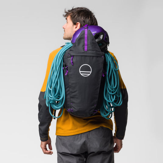 Wild Country Progress Backpack 25L - worn by model with climbing gear in bag (rope and helmet)