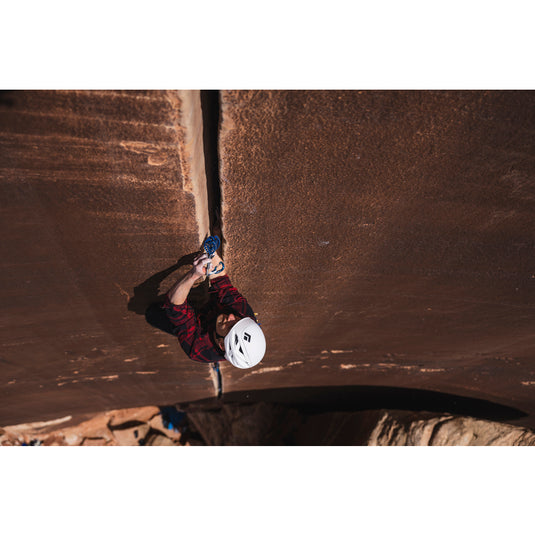 Climber using BD Camalot C4 on climbing rock outside
