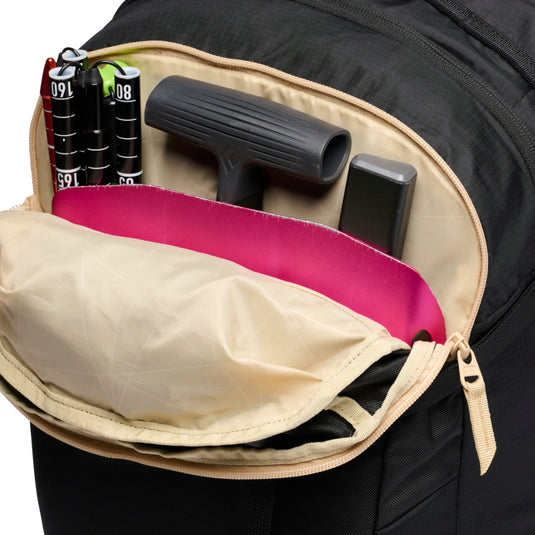 Black Diamond Dawn Patrol 25 Backpack in showing front top pocket with various ski gear 