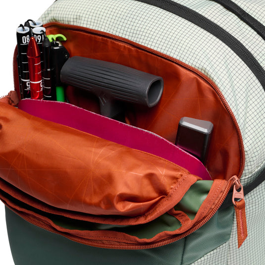 Black Diamond Dawn Patrol 25 Backpack in foam green showing front top pocket with various ski gear 
