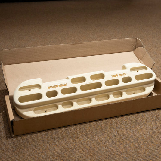 Wooden Training Hangboard - Beastmaker 1000 - with various handholds in cardboard packaging
