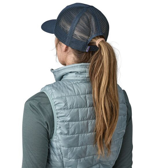 Patagonia P-6 Logo Trucker Hat in new Navy worn by model facing away with ponytail 