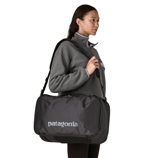 Patagonia Black Hole Mini MLC - 30L in Black on shoulder of model
